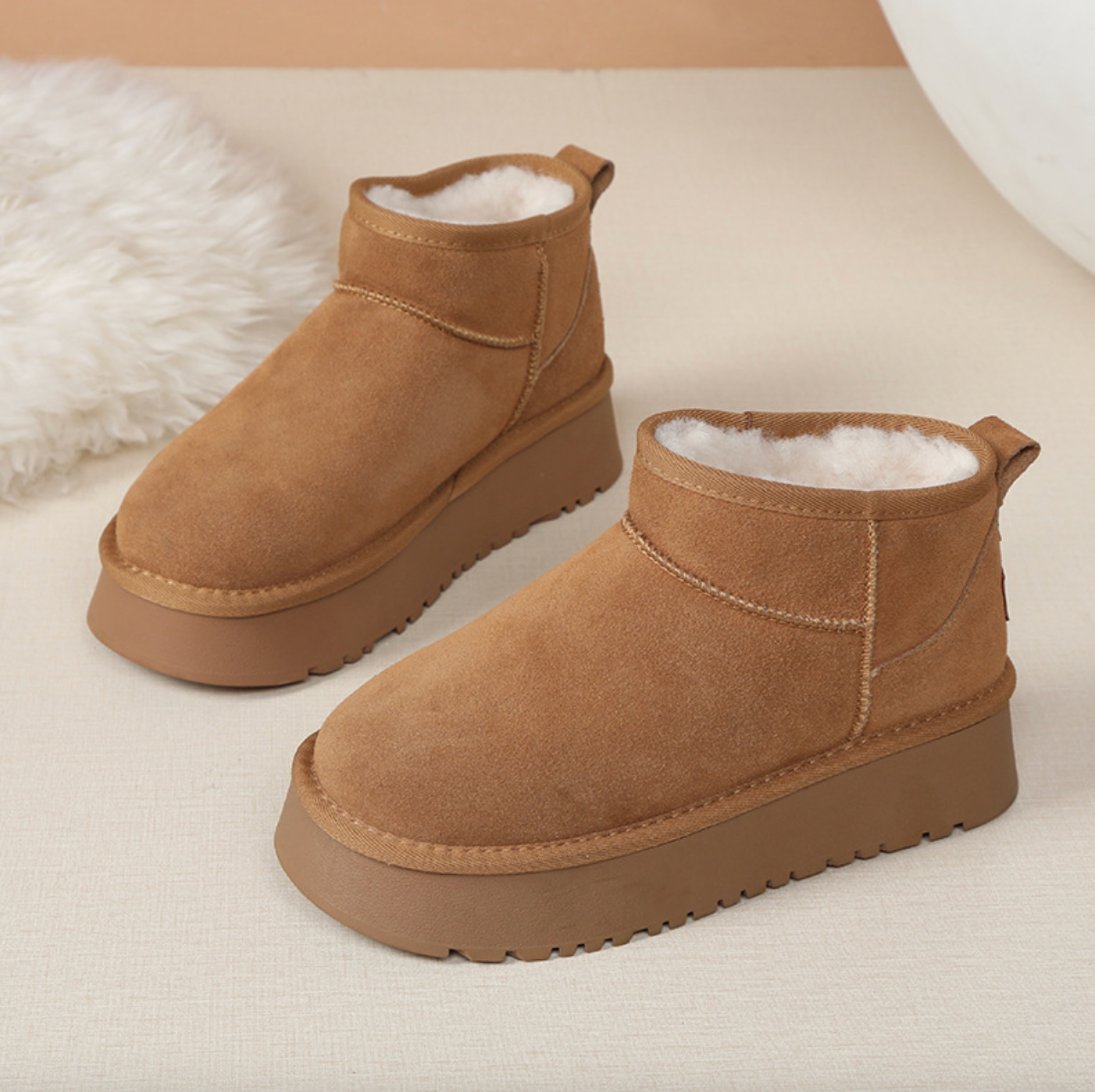 Tan ankle boots with a soft inner lining, featuring a thick sole and suede exterior.